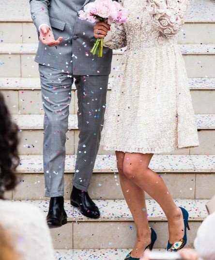 connecticut-limousine-wedding-special a man and woman holding flowers and walking down stairs
